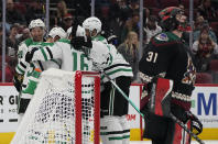 Dallas Stars celebrate a goal by Jason Robertson (21) against Arizona Coyotes goalie Scott Wedgewood (31) during the second period of an NHL hockey game Saturday, Nov. 27, 2021, in Glendale, Ariz. (AP Photo/Darryl Webb)