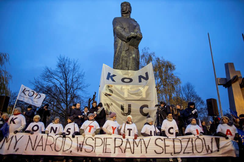 People take part in an anti-government protest in support of free judiciary in Poznan