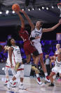 In this photo provided by Bahamas Visual Services, South Carolina guard Destanni Henderson (3) goes to the basket as UConn forward Olivia Nelson-Ododa (20) defends during an NCAA college basketball game at Paradise Island, Bahamas, Monday, Nov. 22, 2021. (Tim Aylen/Bahamas Visual Services via AP)