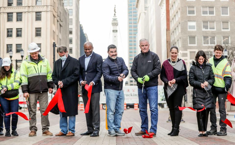 City officials and DPW workers were on hand for a ribbon cutting and reopening ceremony for East Market Street in front of the City County Building on Friday, Dec. 17, 2021, in downtown Indianapolis. The $8 million road reconstruction project closed the heavily foot-trafficked block since September 2020.