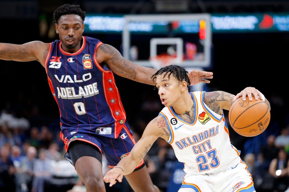 Thunder guard Tre Mann (23) goes past Adelaide 36ers' Robert Franks (0) during an NBA preseason game Thursday night at Paycom Center.