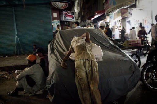 A Pakistani street child and scavenger is seen resting on a covered car in Karachi. According to charities which work to protect street children in Pakistan, up to 90 percent are sexually abused on the first night that they sleep rough and 60 percent accuse police of sexually abusing them