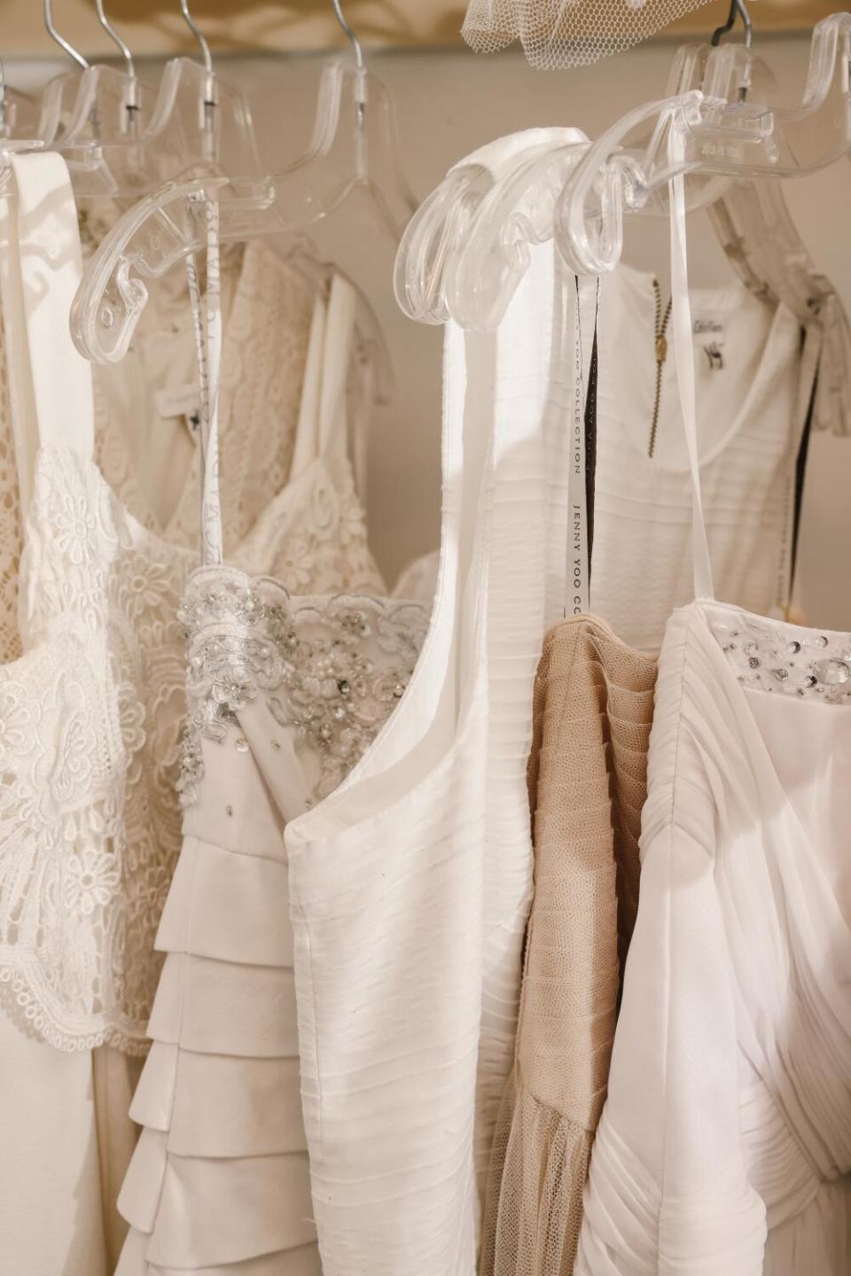 Wedding gowns hang in a bridal suite