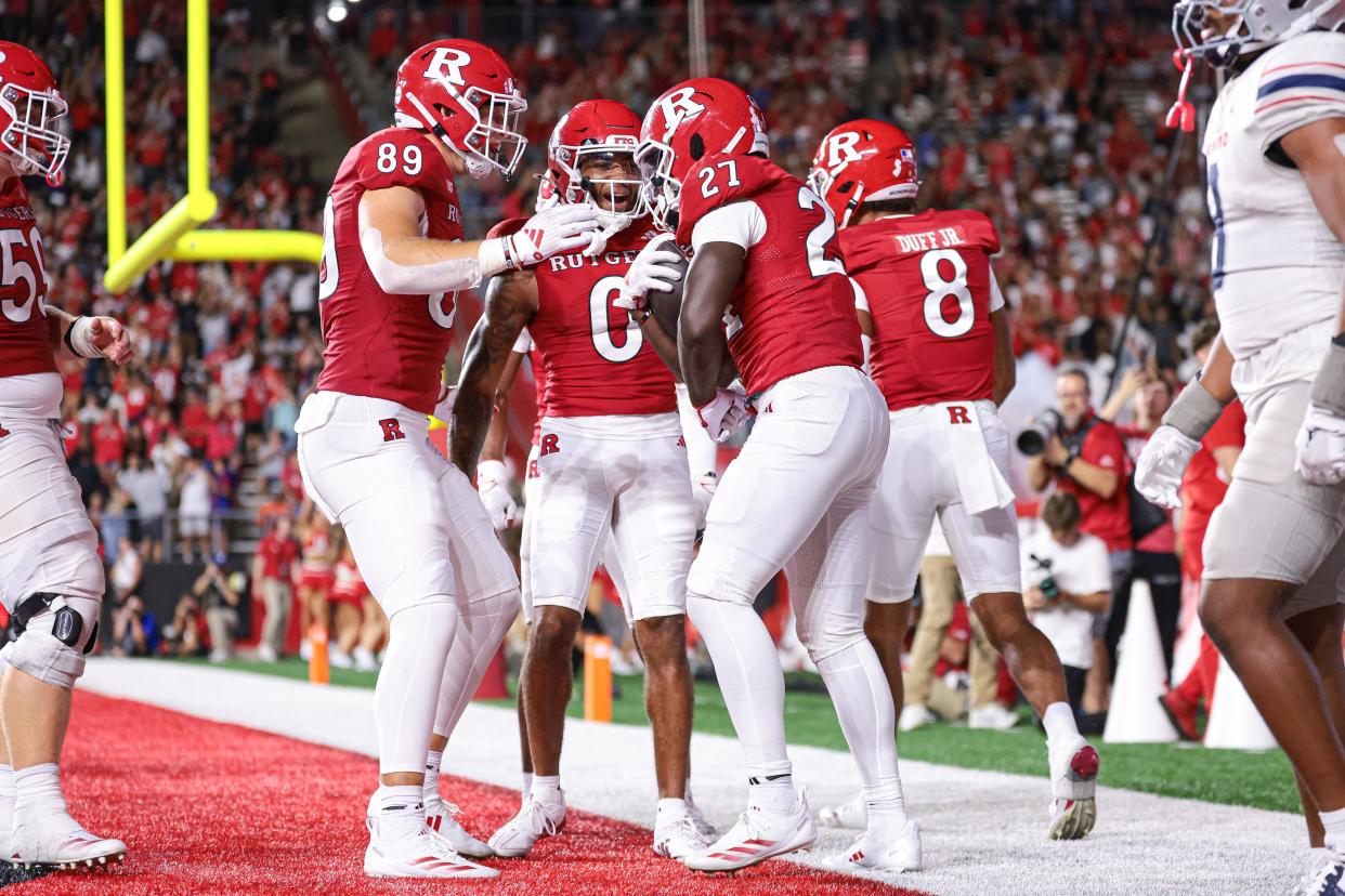 Dymere Miller (No. 0) celebrates with teammates after a Rutgers football touchdown against Howard