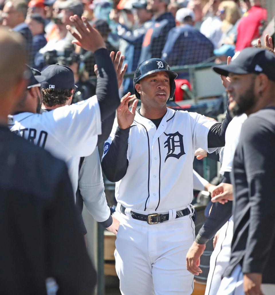 Detroit Tigers second baseman Jonathan Schoop high-fives in the dugout after scoring against the New York Yankees during the eighth inning Thursday, April 21, 2022 at Comerica Park.