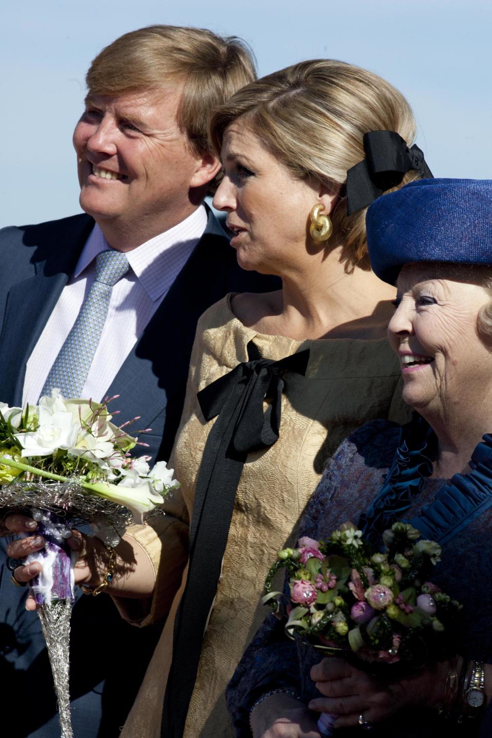 FILE - In this April 30, 2012 file photo, Crown Prince Willem Alexander, his wife Princess Maxima, and Dutch Queen Beatrix, right, listen to singing children during festivities marking Queen's Day in Rhenen, central Netherlands. Queen Beatrix announced she is to abdicate in favor of Crown Prince Willem Alexander during a nationally televised speech Monday, Jan. 28, 2013. Beatrix, who turns 75 on Thursday, has ruled the nation of 16 million for more than 32 years and would be succeeded by her eldest son, Crown Prince Willem-Alexander. (AP Photo/Peter Dejong, File)