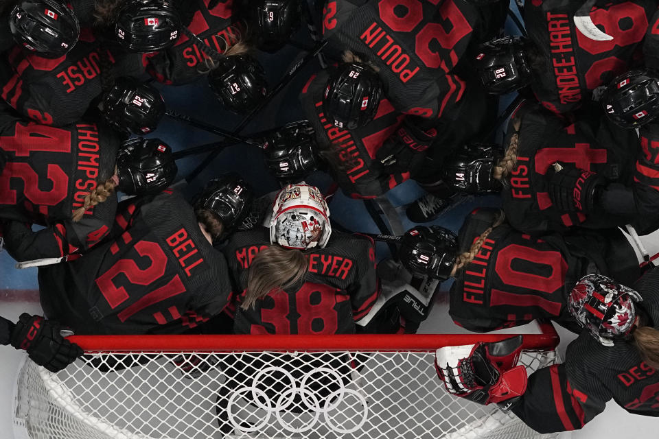 Canada's players huddle prior a women's quarterfinal hockey game between Canada and Sweden at the 2022 Winter Olympics, Friday, Feb. 11, 2022, in Beijing. (AP Photo/Petr David Josek)