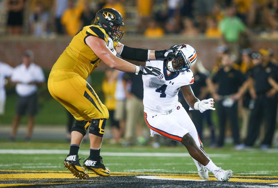 Auburn linebacker Jeff Holland (4) rushes against Missouri offensive lineman Paul Adams (77) during a game Sept. 23, 2017, at Faurot Field.