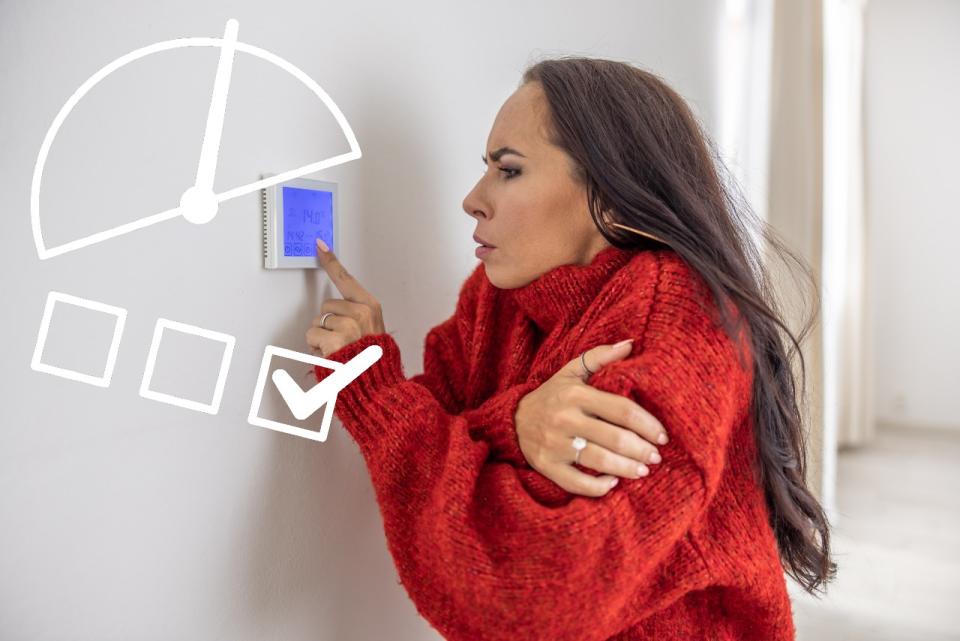 Woman using thermostat 