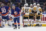 Pittsburgh Penguins' Evgeni Malkin (71) celebrates his goal against the New York Islanders with teammates, including Sidney Crosby, third from right, during the second period of an NHL hockey game Wednesday, April 17, 2024, in Elmont, N.Y. (AP Photo/Seth Wenig)