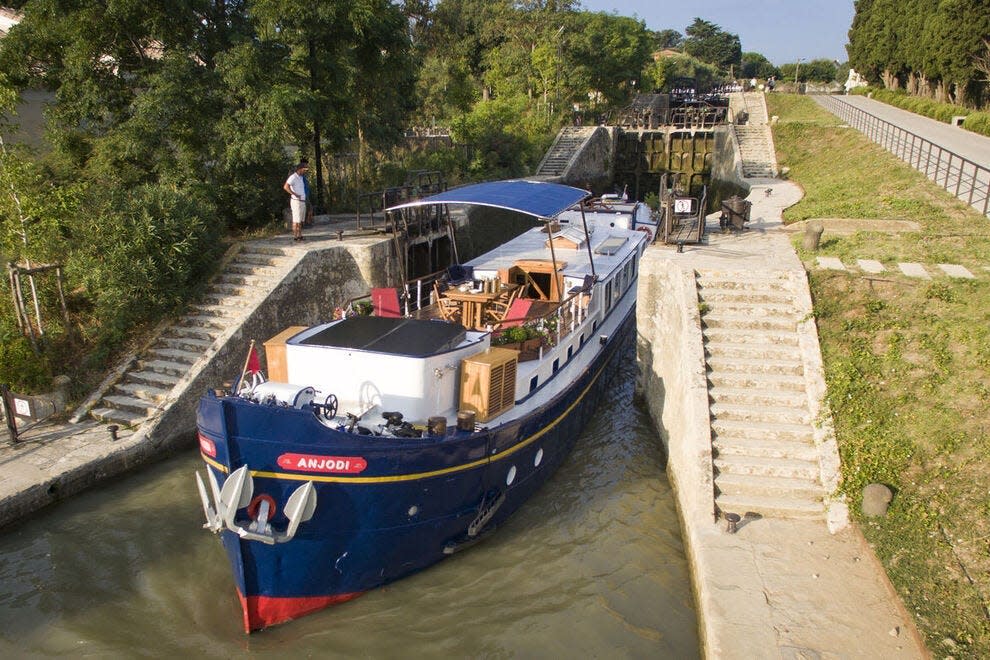 The Anjodi, the founding member of the European Waterways fleet, cruises on the Canal du Midi in southern France