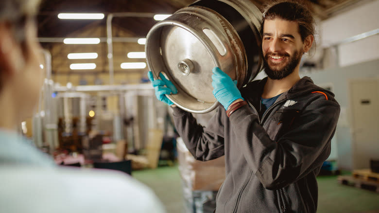 man holding keg