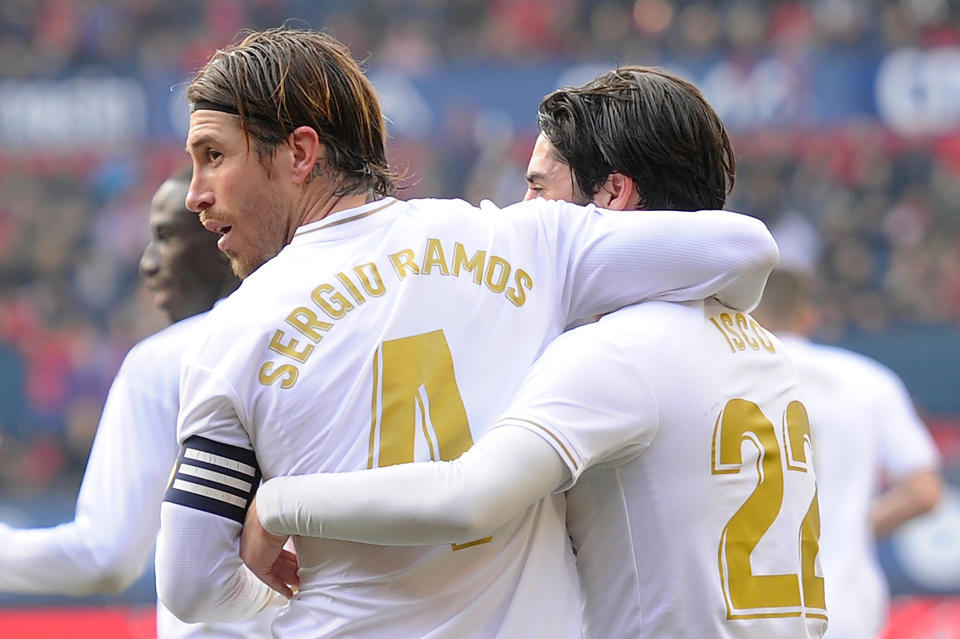 Real Madrid's Spanish defender Sergio Ramos (L) celebrates his goal with teammates during the Spanish league football match between CA Osasuna and Real Madrid CF at El Sadar stadium in Pamplona on February 9, 2020.