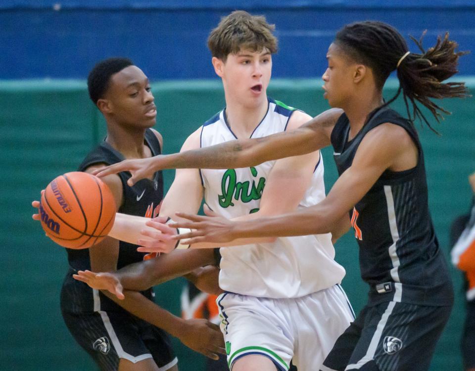 Peoria Notre Dame's Eoin Dillon, facing, tangles with Manual's Dietrich Richardson in the first half of their boys basketball game Friday, Dec. 2, 2023 at PND High School. The Rams defeated the Irish 46-43.