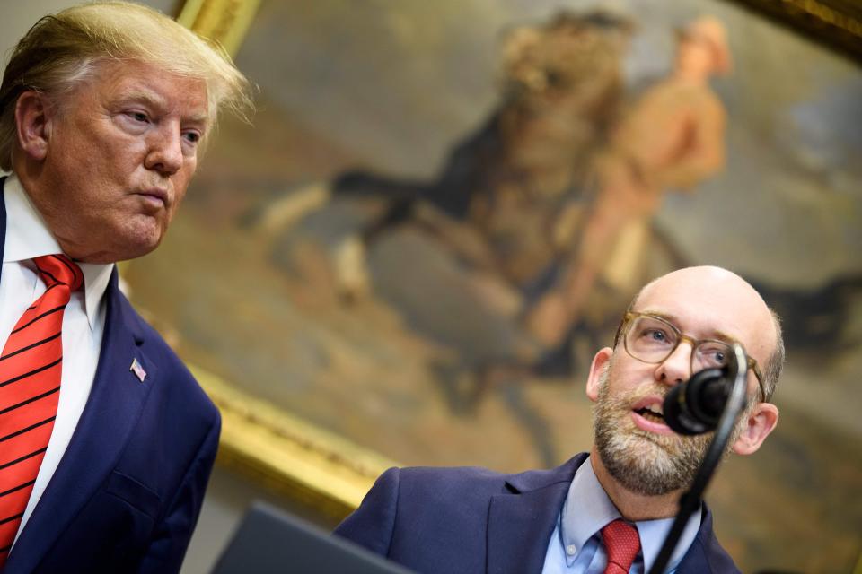 Then-President Donald Trump listens while acting Office of Management and Budget director Russell Vought speaks during an executive order signing regarding federal regulations at the White House on October 9, 2019.