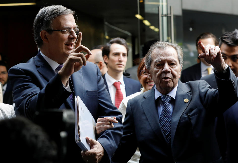 Mexico's Foreign Minister Marcelo Ebrard (L) and lawmaker Porfirio Munoz Ledo of the ruling Morena party gesture while arriving to the Senate building in Mexico City, Mexico June 14, 2019. REUTERS/Carlos Jasso