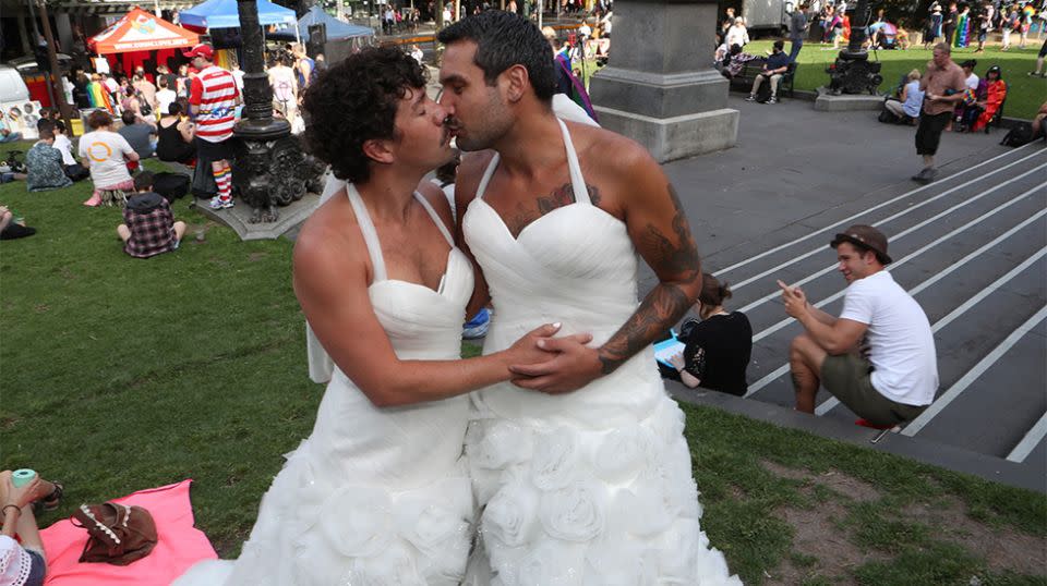 Two men dresses as brides are seen as people begin to gather in front of the State library of Victoria for the outcome of the Same Sex Marriage postal survey. Source: AAP