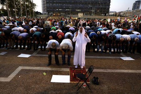 Israeli Arabs pray during a rally to protest against Jewish nation-state law in Rabin square in Tel Aviv, Israel August 11, 2018. REUTERS/Ammar Awad