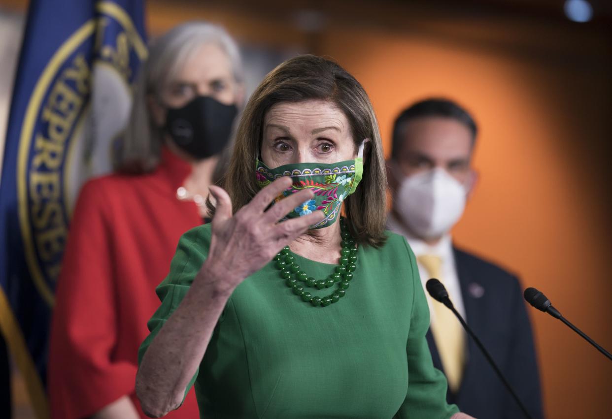 Speaker of the House Nancy Pelosi, D-Calif., meets with reporters before the House votes to pass a $1.9 trillion pandemic relief package, during a news conference at the Capitol in Washington, Friday, Feb. 26, 2021. Pelosi is flanked by Rep. Katherine Clark, D-Mass., left, and Rep. Pete Aguilar, D-Calif. 