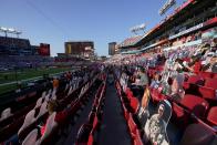 Fans sit near cutouts in the stands at Raymond James Stadium before the NFL Super Bowl 55 football game between the Kansas City Chiefs and Tampa Bay Buccaneers, Sunday, Feb. 7, 2021, in Tampa, Fla. (AP Photo/Gregory Bull)