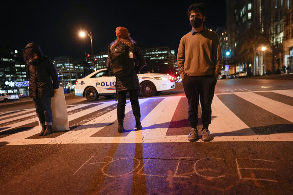 Demonstrators block K Street NW, and a D.C. Metropolitan Police car is behind, as they protest Friday, Jan. 27, 2023, in Washington, the death of Tyre Nichols, who died after being beaten by Memphis police officers on Jan. 7. (AP Photo/Carolyn Kaster)