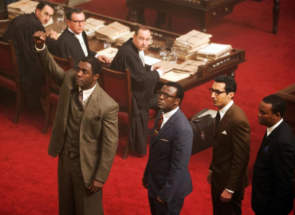This photo released by The Weinstein Company shows, standing from left, Idris Elba, as Nelson Mandela, Tony Kgorge as Walter Sisulu, Riaad Moosa, as Ahmed Kathrada, and Thapelo Mokena as Elias Motsoaledi, in a scene from the film, "Mandela: Long Walk to Freedom." (AP Photo/The Weinstein Company, Keith Bernstein)