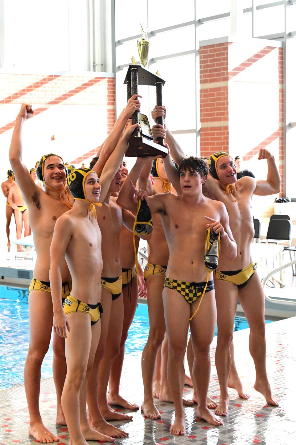 The Golden Bears of Upper Arlington hoist the title trophy at the 2021 Ohio Water Polo Boys State Championship, Oct. 31, 2021.