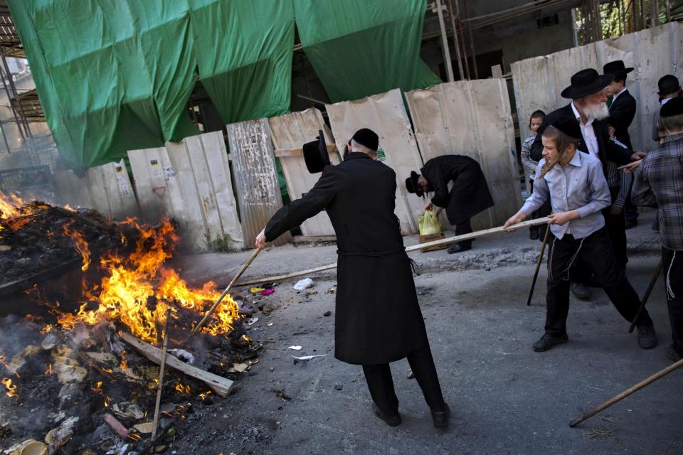 Ultra-Orthodox Jewish men burn leavened items in final preparation for the Passover holiday in the ultra-Orthodox Jewish town of Bnei Brak, near Tel Aviv, Israel, Monday, April 14, 2014. Jews are forbidden to eat leavened foodstuffs during the Passover holiday that celebrates the biblical story of the Israelites' escape from slavery and exodus from Egypt. (AP Photo/Oded Balilty)