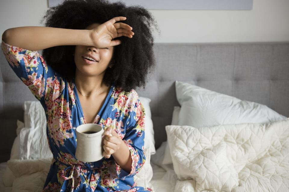 A woman drinks coffee in the morning.