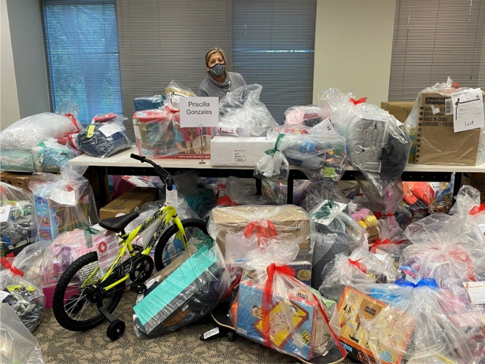 Priscilla Gonzales, a Family Resource Specialist at DePelchin Children’s Center in Houston, Texas, is seen picking up donated holiday gifts that she will deliver to her clients before Christmas in 2020.