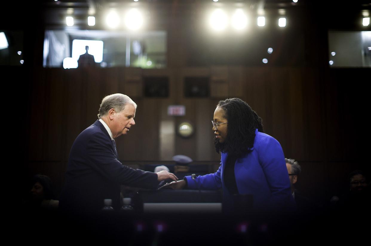 U.S. Supreme Court nominee Judge Ketanji Brown Jackson talks to former Sen. Doug Jones (D-AL) as she arrives for the third day of her confirmation hearing before the Senate Judiciary Committee in the Hart Senate Office Building on Capitol Hill on March 23, 2022, in Washington, DC.