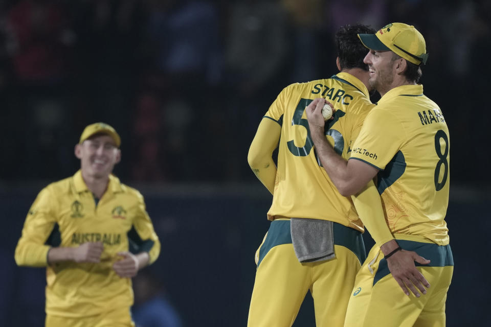 Australian players celebrate after they won the ICC Men's Cricket World Cup match against New Zealand in Dharamshala, India,Saturday, Oct. 28, 2023. (AP Photo/Ashwini Bhatia)