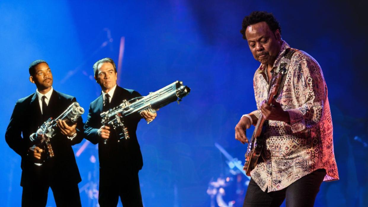  Will Smith and Tommy Lee aiming their weapons in a scene from Men in Black. Freddie Washington performs at Bass Player Live. . 