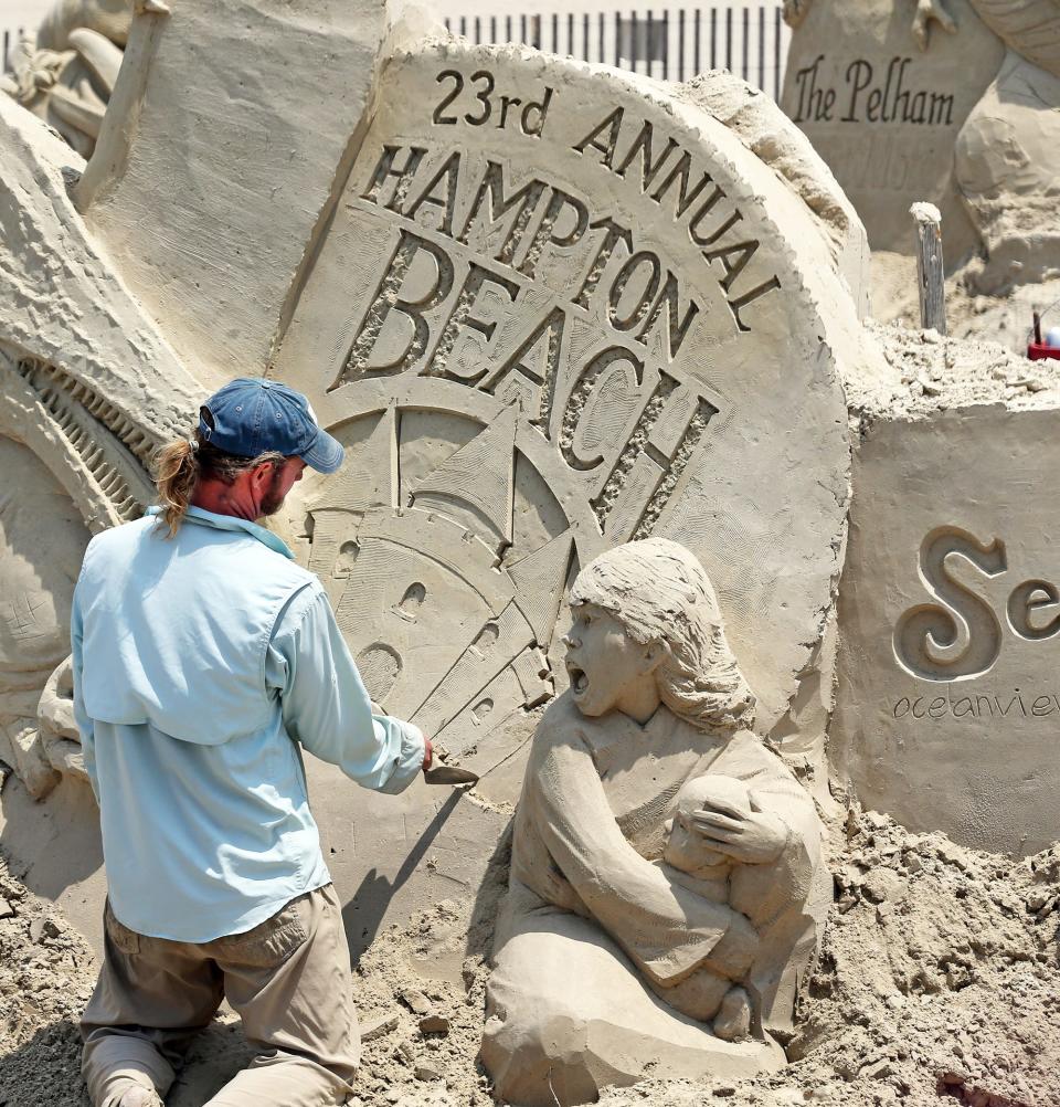 Sculptor Abe Waterman, of Prince Edward Island, Canada, works on creating the sponsor site for the 23rd Hampton Beach Sand Sculpting Classic June 12, 2023.