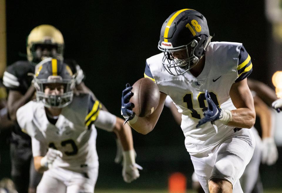 Lausanne's Ben Bolton (18) picks up a ball fumbled by First Assembly Christian School and runs it in for a touchdown Friday, Sept. 4, 2020, during a game at First Assembly Christian School in Cordova.