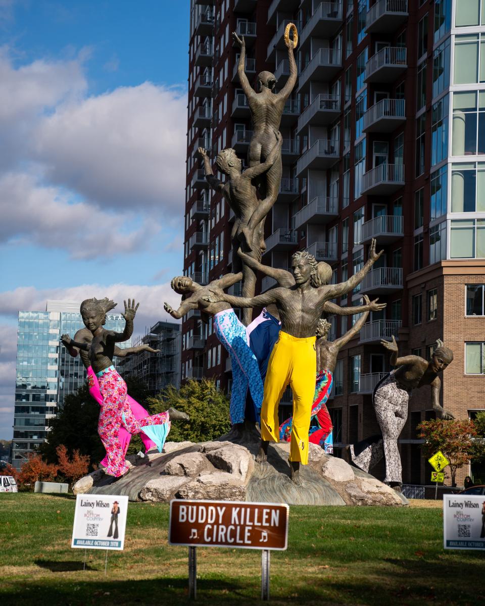 Colorful bell-bottomed pants are seen on Alan LeQuire's Musica statue in Buddy Killen Circle in Nashville, Tenn., Wednesday, Oct. 26, 2022.  The pants were placed on the statue to promote Lainey Wilson's album "Bell Bottom Country.”