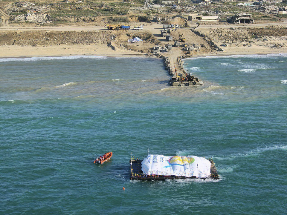 In this photo provided by the Israeli Army, humanitarian aid transported from a ship from the World Central Kitchen (WCK) organization, led by the United Arab Emirates, arrives in the Gaza Strip’s maritime space, Friday, March 15, 2024. The Israeli military says a ship has delivered 200 tons of food, water and humanitarian supplies to Gaza, inaugurating a sea route from Cyprus. The sea route is intended to bring more assistance to alleviate the humanitarian crisis in the enclave five months into the war between Israel and Hamas. (Israeli Army via AP)