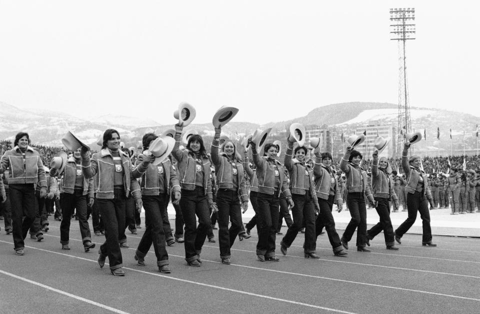 American Olympic athletes wave the cowboy hats that are part of their official Olympic uniforms on Wednesday, Feb. 8, 1984 as they march in Kosevo Stadium during opening ceremonies of the XIV Winter Games in Sarajevo, Yugoslavia.