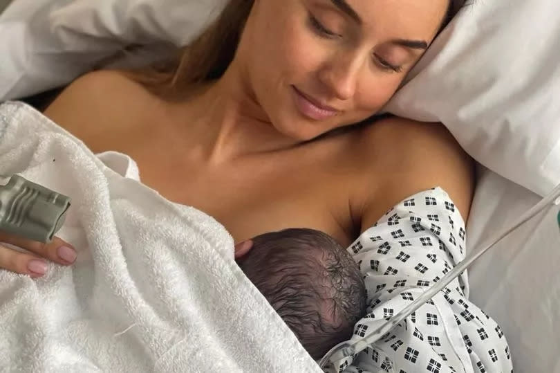 Emily holding their little one after birth