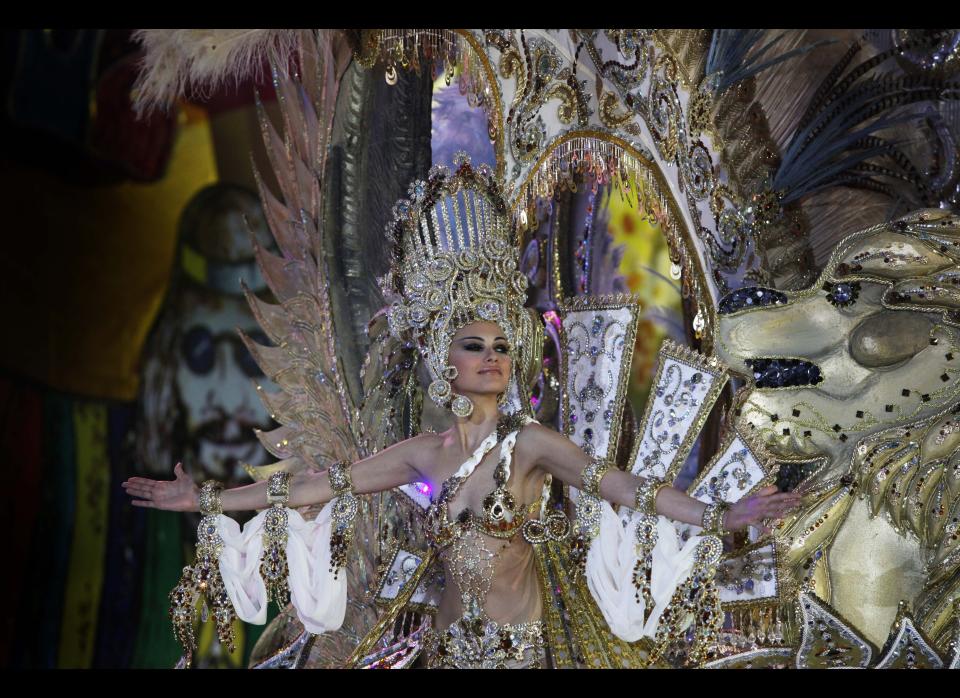 A nomine for Queen of the Santa Cruz carnival shows off her outfit under the watchful eyes of the jury at Santa Cruz de Tenerife on the Spanish Canary island of Tenerife, February 15, 2012. (DESIREE MARTIN/AFP/Getty Images)