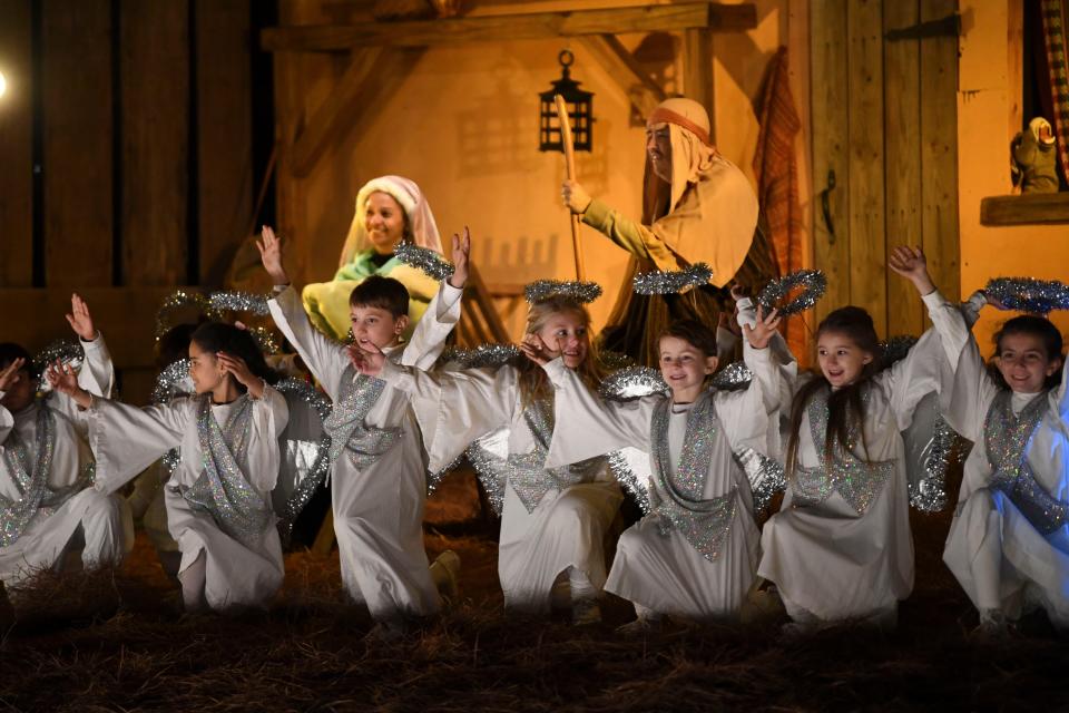 Actors portraying angels dance during a Live Outdoor Christmas Nativity Pageant: The Story of Christmas outside 904 Princeton Place in Northport Tuesday, Dec. 19, 2023.