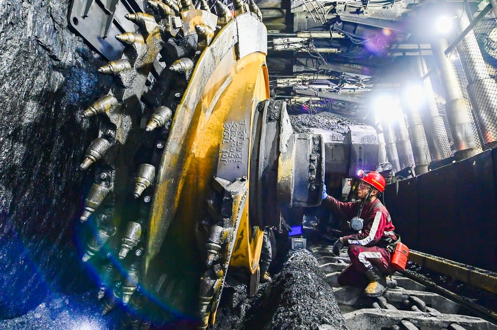 A worker checks equipment at a coal mine in Ordos, Inner Mongolia, China. Reducing demand for coal is crucial for meeting climate targets, say scientists  (Getty Images)