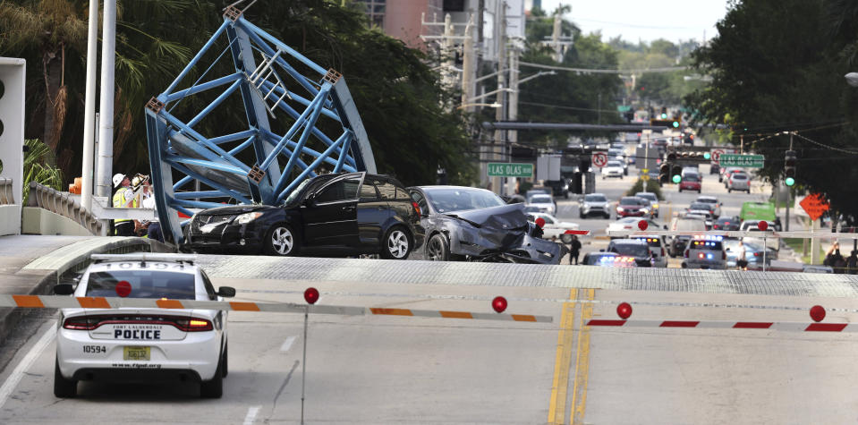 A construction worker was killed and two people were taken to the hospital after a portion of a crane dropped onto the Southeast Third Avenue bridge over the New River in downtown Fort Lauderdale, Fla., Thursday afternoon, April 4, 2024. (Carline Jean/South Florida Sun-Sentinel via AP)