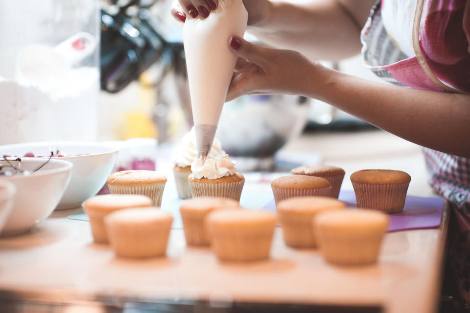 Woman frosting cupcakes