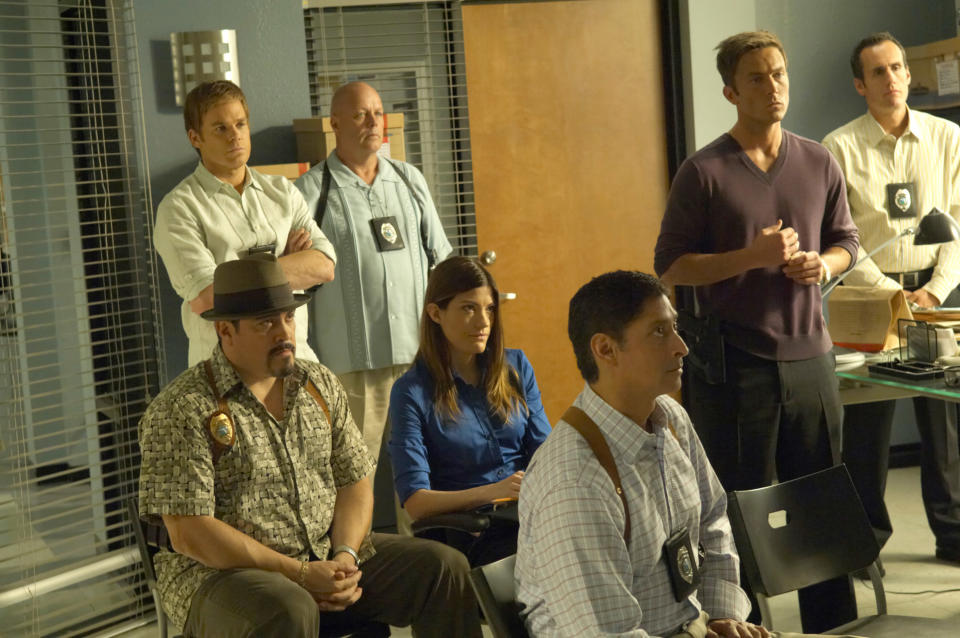 Michael C. Hall, David Zayas, Jennifer Carpenter and Desmond Harrington are at an office briefing