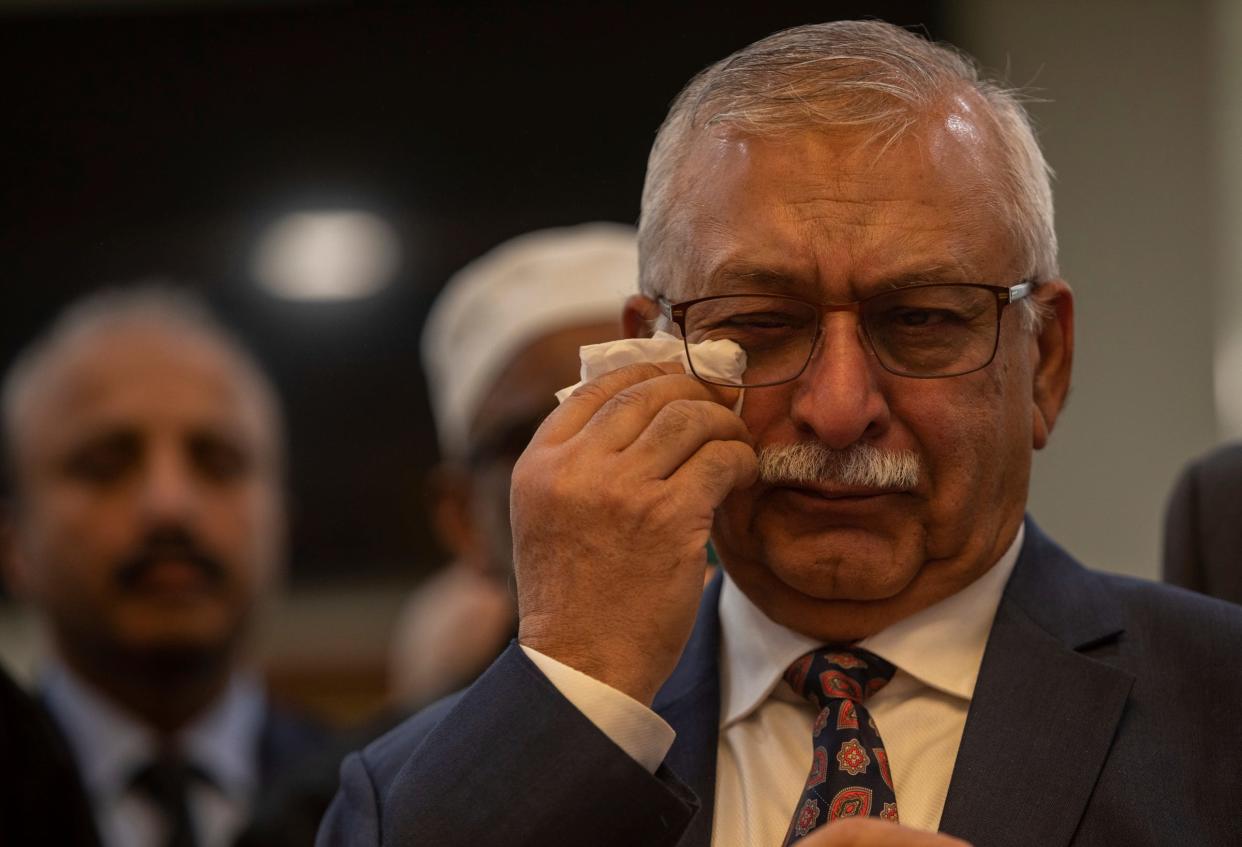 Co-founder Dr. Ghaus Malik wipes a tear from his eye during a ribbon-cutting ceremony inside the Islamic Association of Greater Detroit's (IAGD) newly expanded mosque in Rochester Hills on Saturday, March 2, 2024.