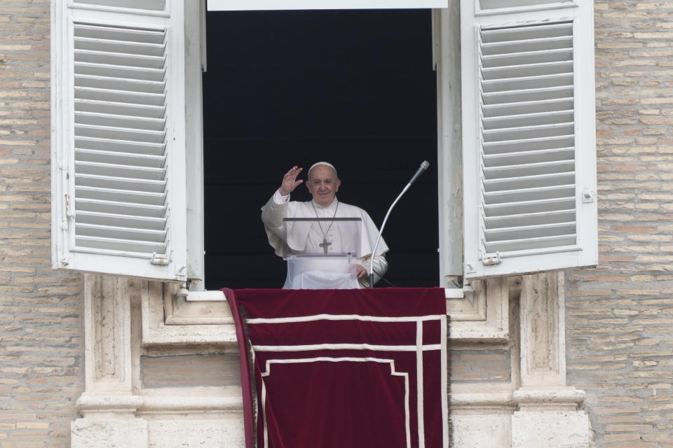 FILE - In this June 29, 2021, file photo, Pope Francis salutes from the window of his studio overlooking St. Peter's square at the Vatican, as he recites the Angelus prayer. The Vatican has detailed laws, rituals and roles to ensure the transfer of power when a pope dies or resigns. Even though Pope Francis is recovering from intestinal surgery in a Rome hospital, he is still very much in charge. (AP Photo/Gregorio Borgia, File)