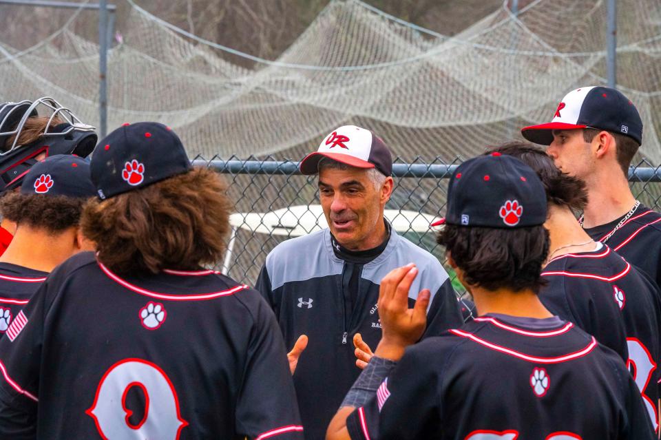 Old Rochester coach Steve Carvalho speaks to the team between innings earlier this season. On Monday, the Bulldogs beat Apponequet in a walk-off win.