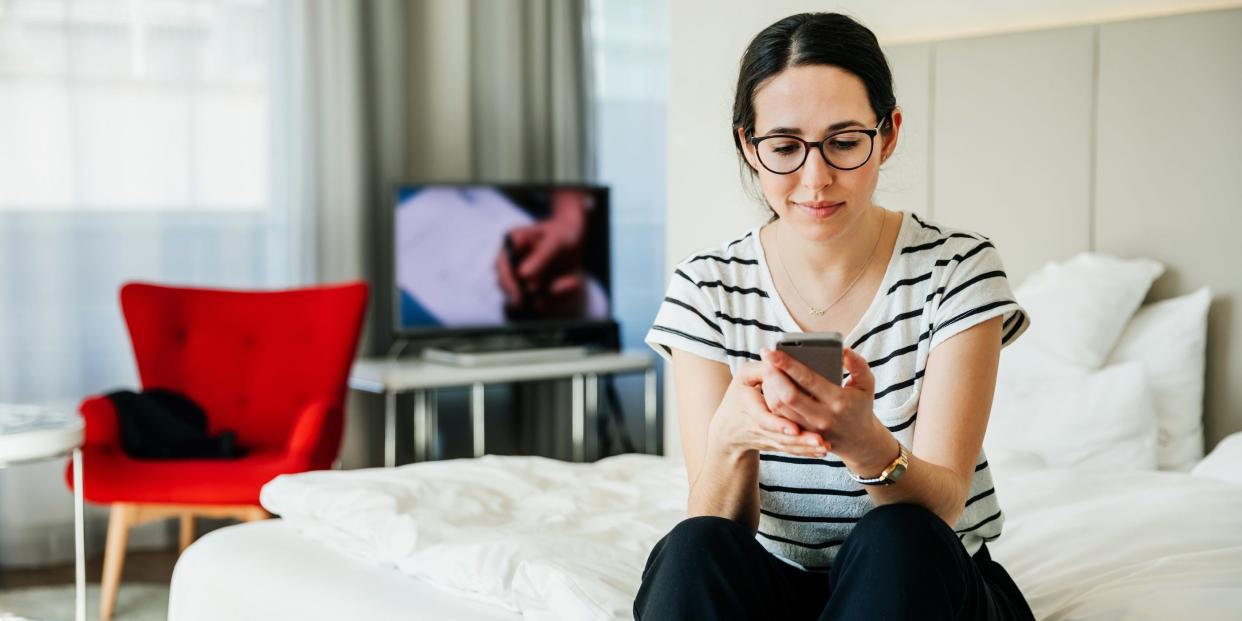 woman holding using phone tv movie at home