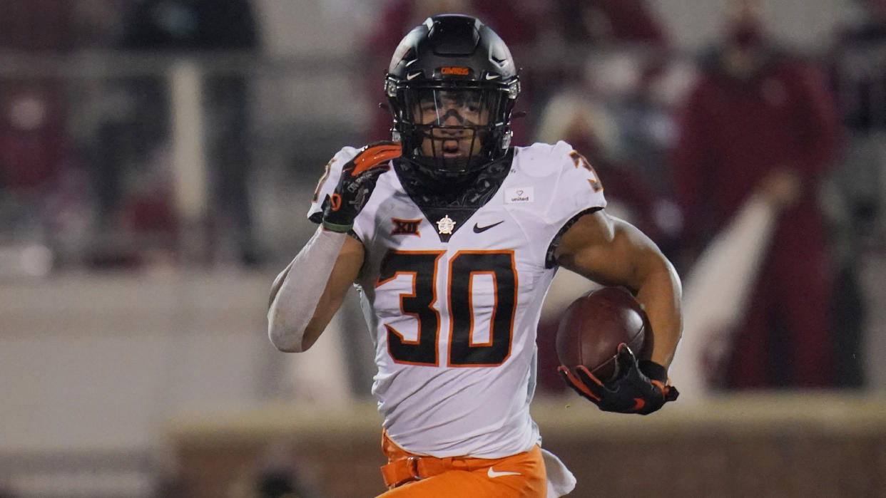 Oklahoma State running back Chuba Hubbard (30) carries during an NCAA college football game against Oklahoma in Norman, Okla., Saturday, Nov. 21, 2020. (AP Photo/Sue Ogrocki)